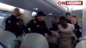 IDIOT Police haul terror suspect off the plane