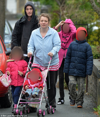 Worthless mother of four Lauren Beckham (pictured with an unidentified man) and her four children