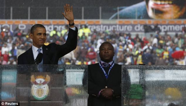 U.S. President Barack Obama addresses the crowd while the 'interpreter' stands next to him