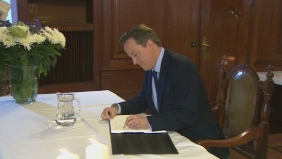 PM David Cameron signs Mandela's book of condolence