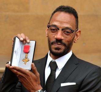 Photograph courtesy of The Voice: Darcus Beese poses with his OBE