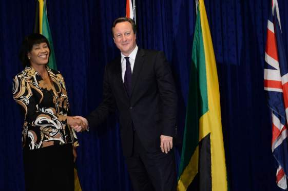 Cameron visit to Caribbean - Day One. Prime Minister David Cameron is greeted by Jamaican Prime Minister Portia Simpson-Miller at her office, Jamaica House, in Kingston, on the first of a two day visit to the Caribbean. Picture date: Tuesday September 29, 2015. The Prime Minister flew into Jamaica promising a Â£200 million infrastructure aid boost to "reinvigorate" ties with the region - with UK firms set to compete to build roads, ports and bridges. See PA story POLITICS Cameron. Photo credit should read: Stefan Rousseau/PA Wire URN:24284816